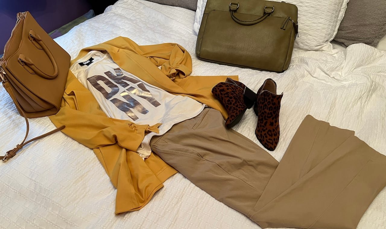 An assortment of designer clothing and accessories, including DKNY labeled T-shirt, from Kendrick’s wardrobe. 