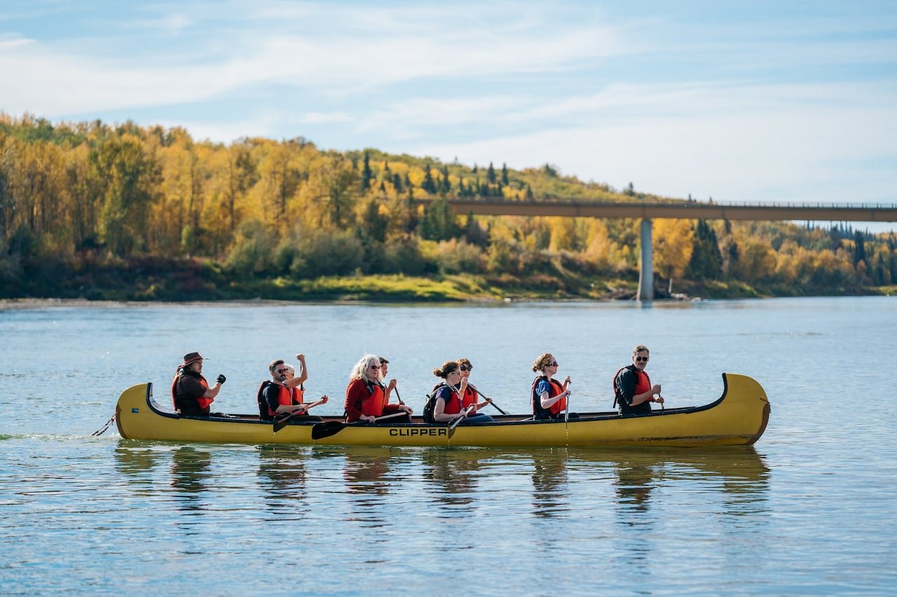 default-42 Image of people in a long canoe on a river.